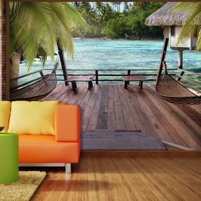 Fototapetas Artgeist Tropical Landscape - Turquoise water with palm trees and wooden cottages XLNEW010218, 175 cm x 250 cm